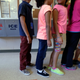 In this Sept. 10, 2014, file photo, detained immigrant children line up in the cafeteria at the Karnes County Residential Center, a temporary home for immigrant women and children detained at the border, in Karnes City, Texas.